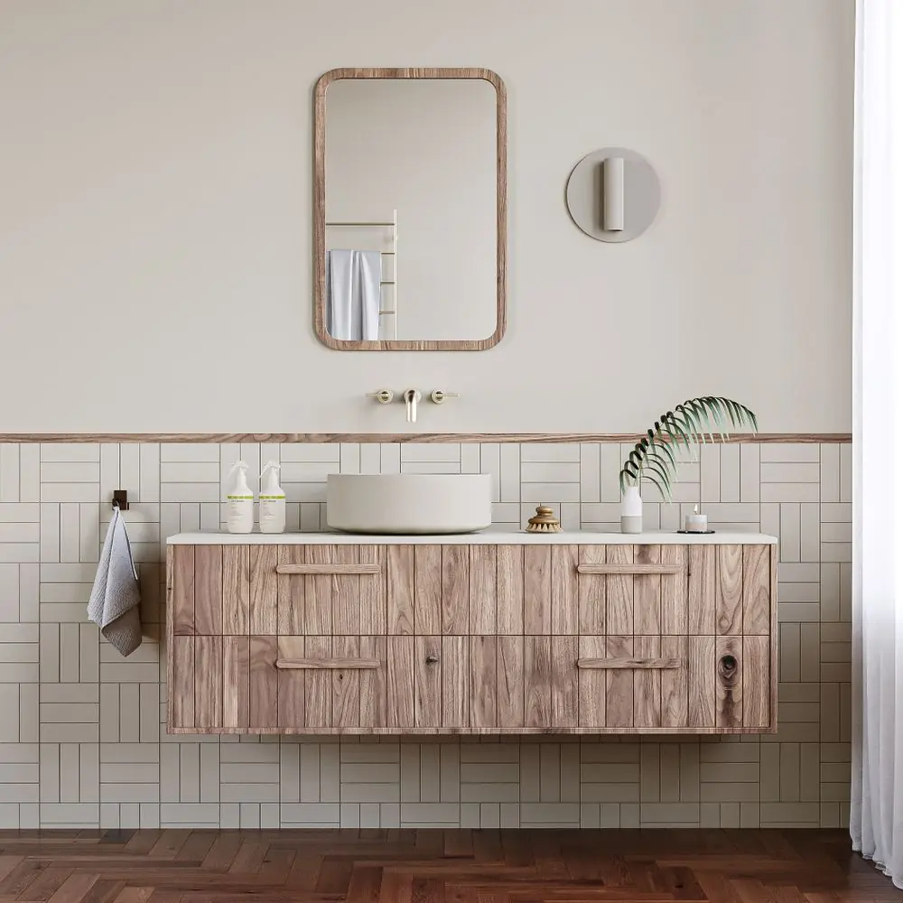 A tidy bathroom vanity with a folded towel and a small plant