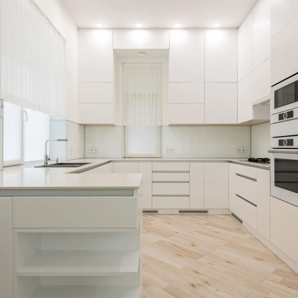 A bright white kitchen with clear, wiped down counters