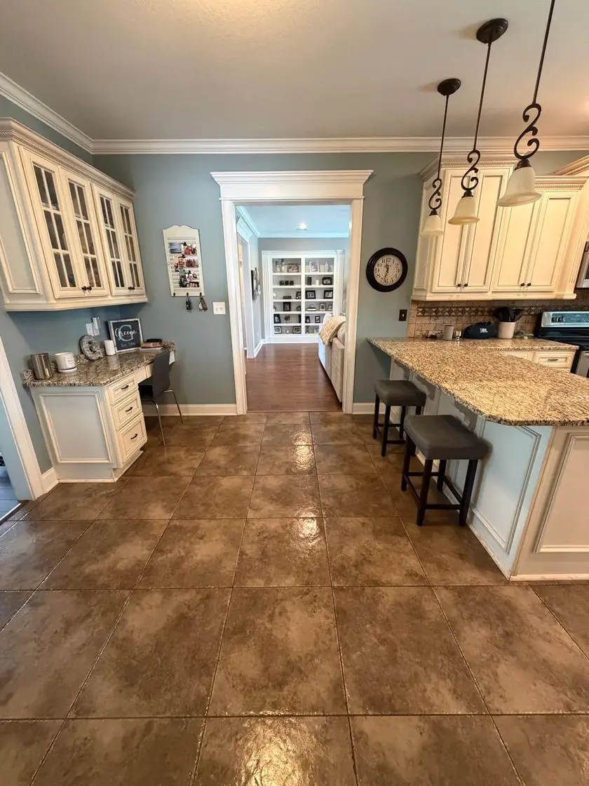 A kitchen island with a breakfast bar and pendant lights